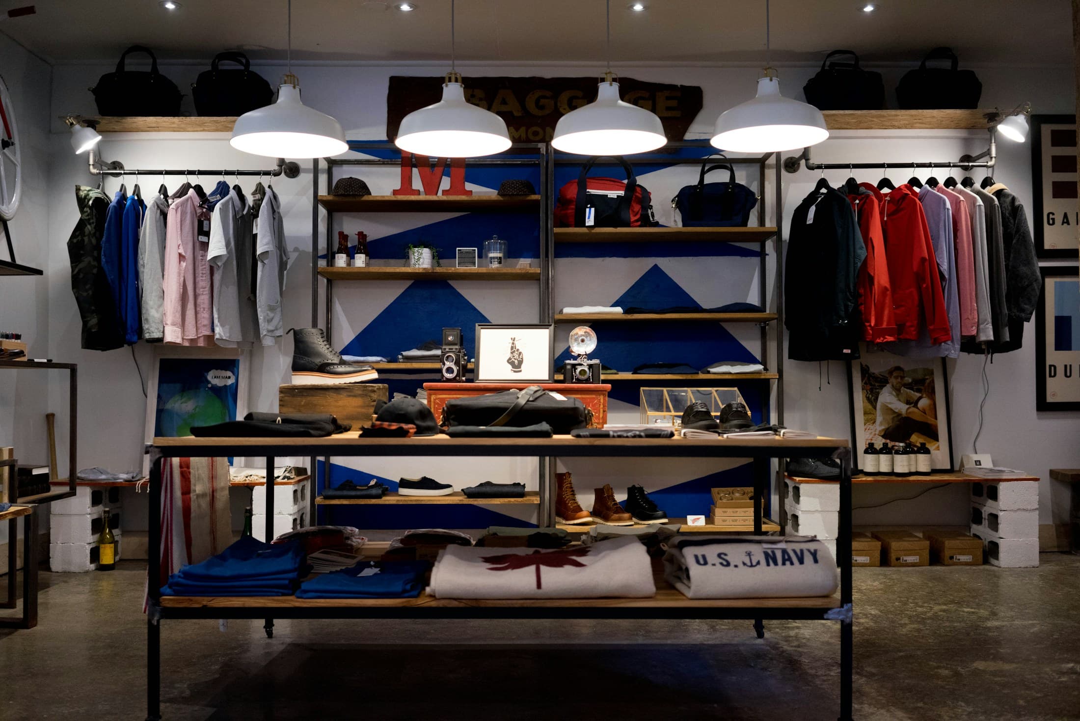 An independent clothing shop with neatly arranged rails, shelves and a bright shopfront